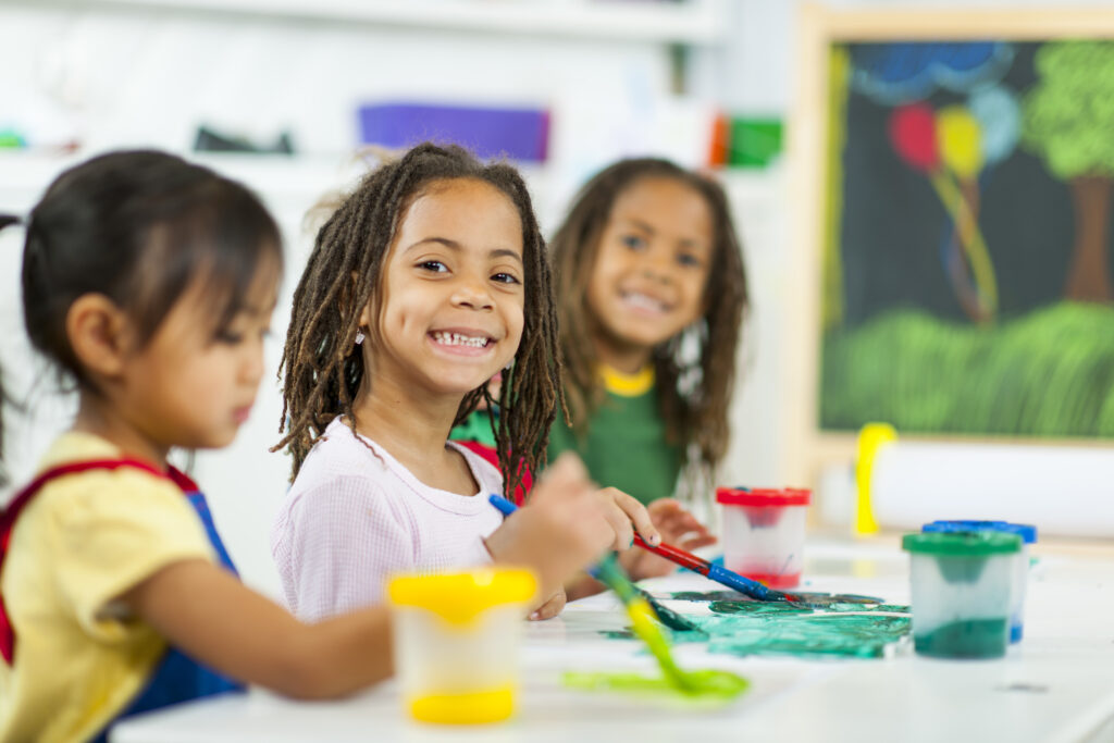 Sunrise Preschools Infinity Explorers Adventure Summer Camp 4 Diverse group of elementary school students doing art together.
