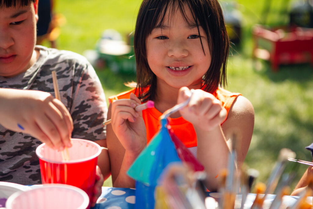 Sibling painting during summer camp