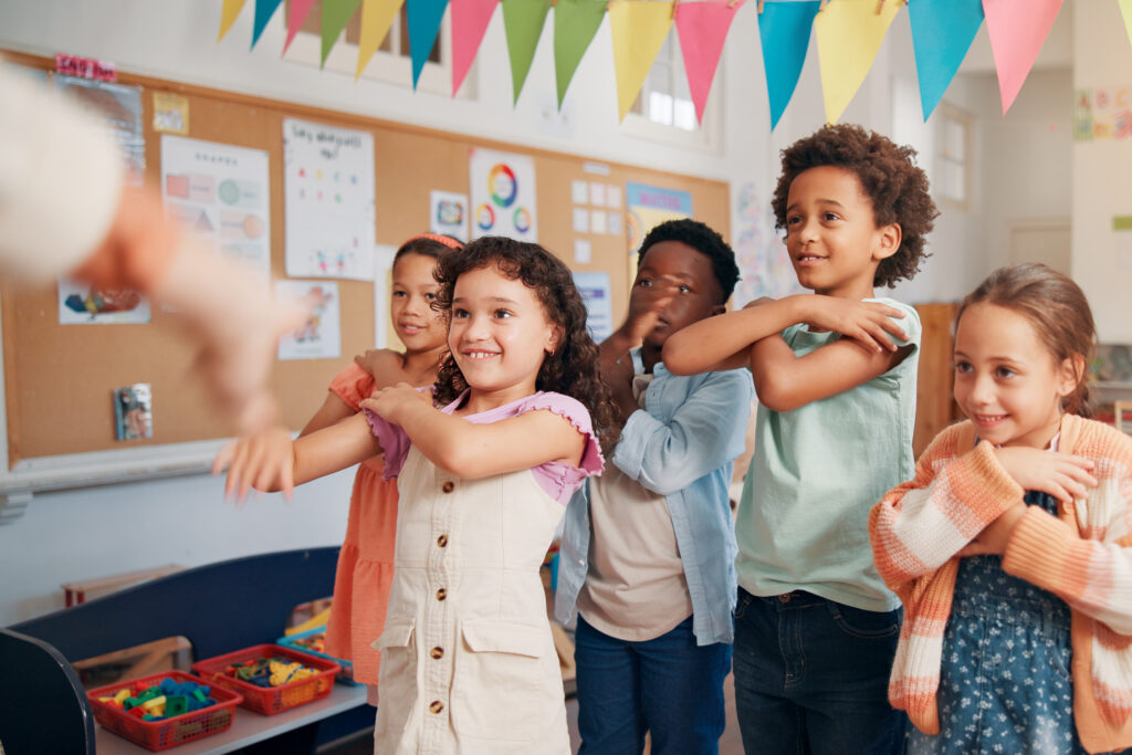 Education, dance and group of kids in classroom together for coordination or motor skills development. Children, learning or study with boy and girl students in school for scholarship as friends