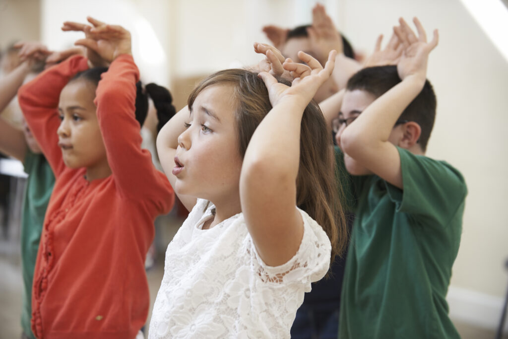 Group Of Children Enjoying Drama Class Together